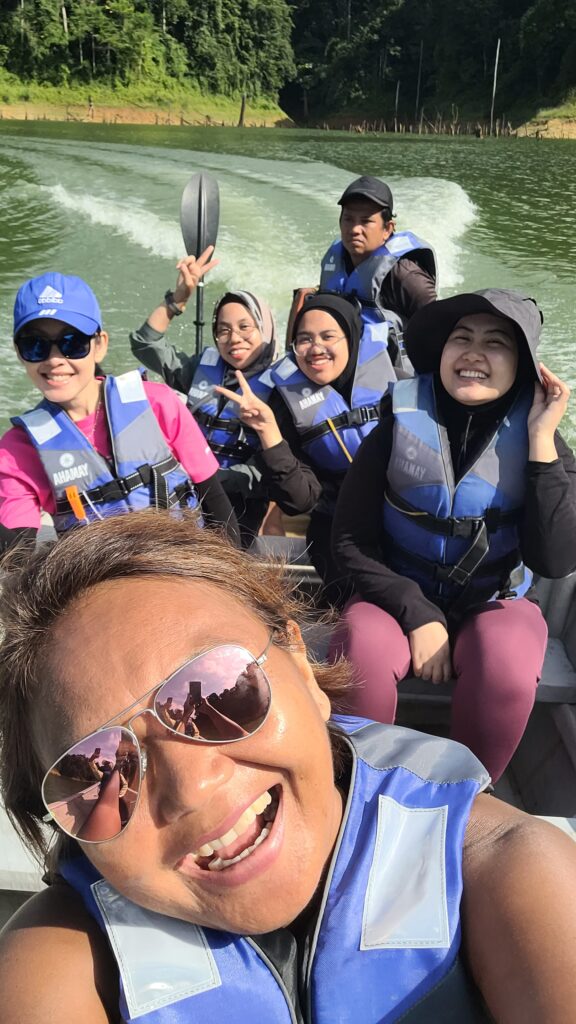 Visitors on a wooden boat exploring Lake Temenggor in Royal Belum State Park