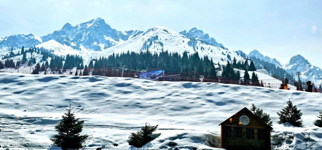 View of the snowy mountain slopes at Shymbulak Ski Resort in Kazakhstan, photographed from my hotel room.
