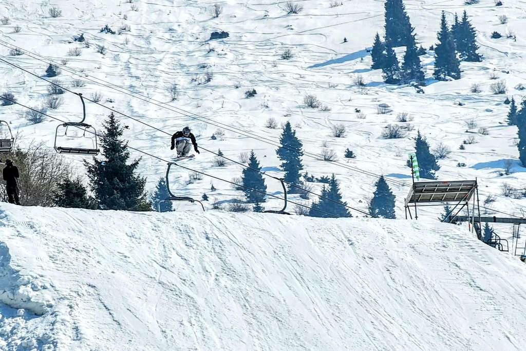 Snowboarder flying off a ramp during the Big Air competition at the Gorilla Winter Jungle Festival in Shymbulak.
