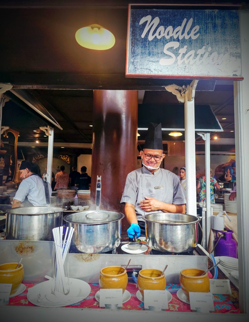 “Chef preparing noodles at the live station in Dayang Café during breakfast at Berjaya Langkawi