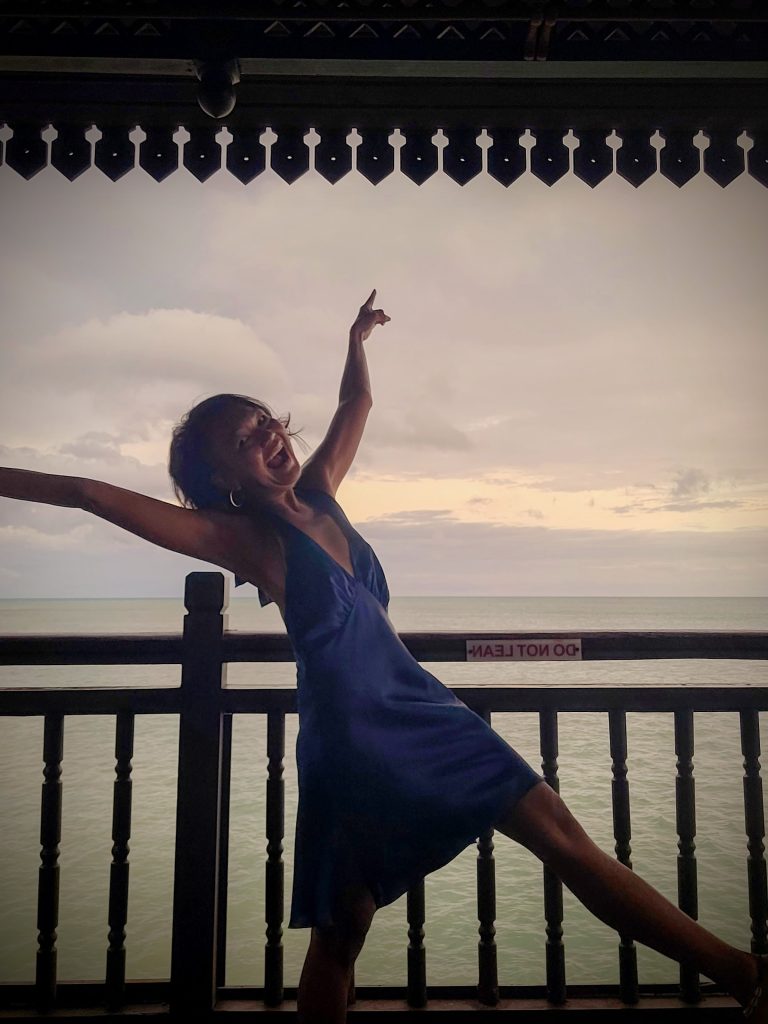 Guest enjoying sunrise and ocean views from the terrace of a water chalet at Berjaya Langkawi