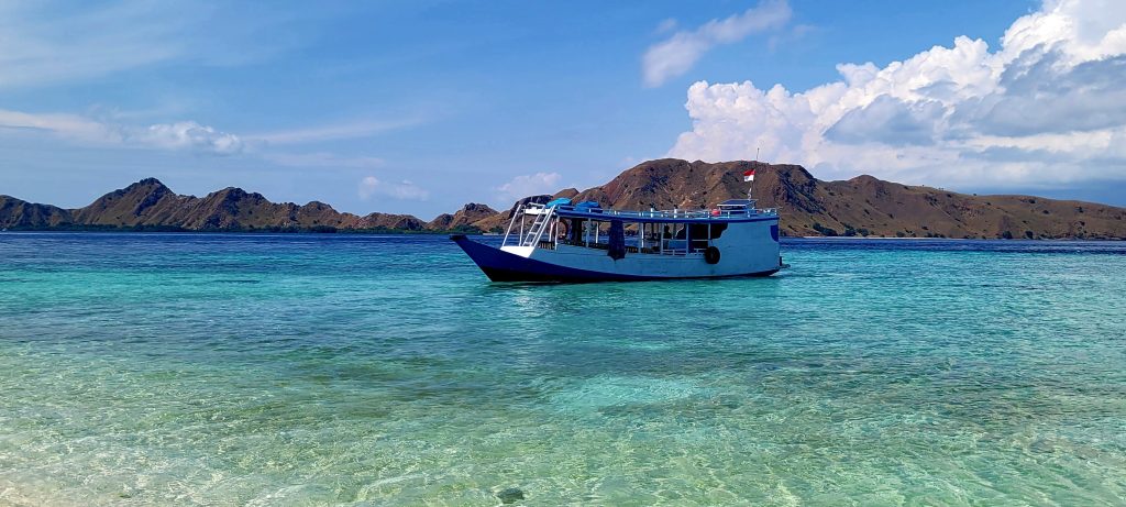 Small wooden boat chartered in Labuan Bajo for a Komodo Islands trip