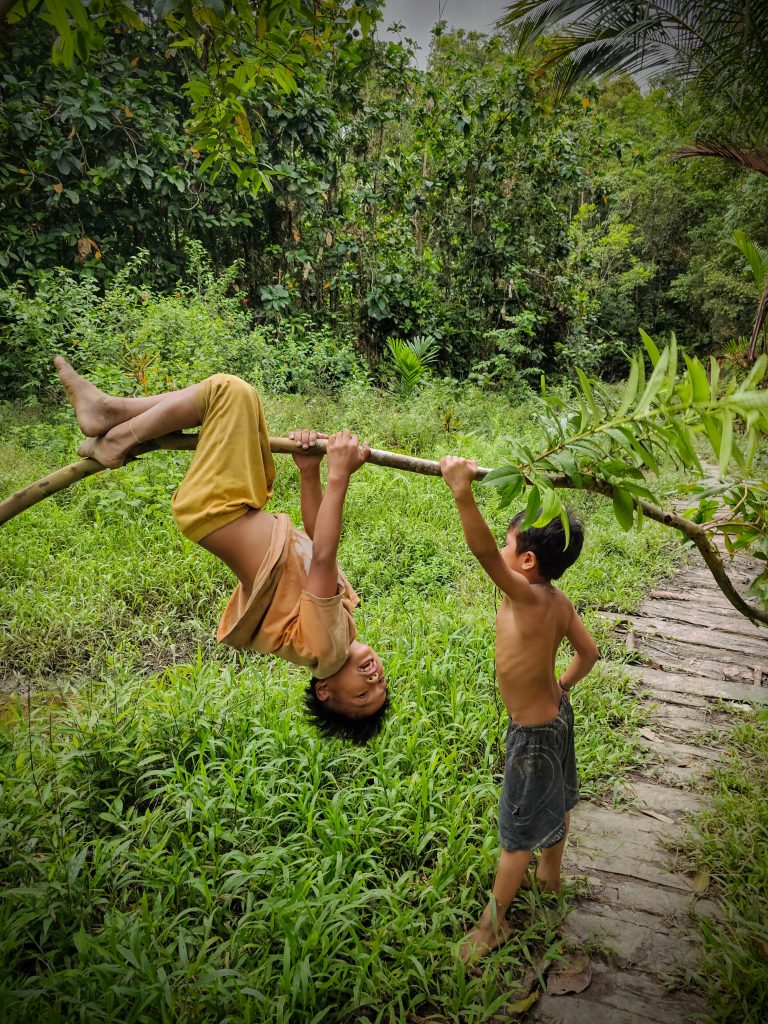 Mentawai children climbing trees and playing in the Siberut jungle.