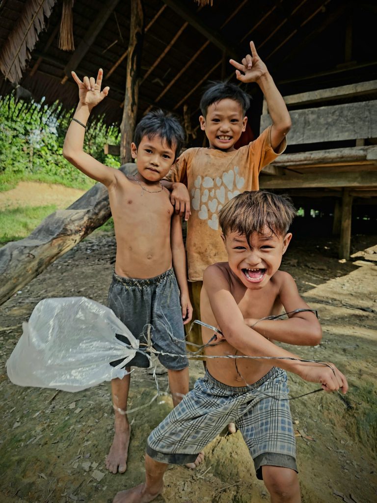 Mentawai children playing outside the uma, surrounded by the Siberut jungle.