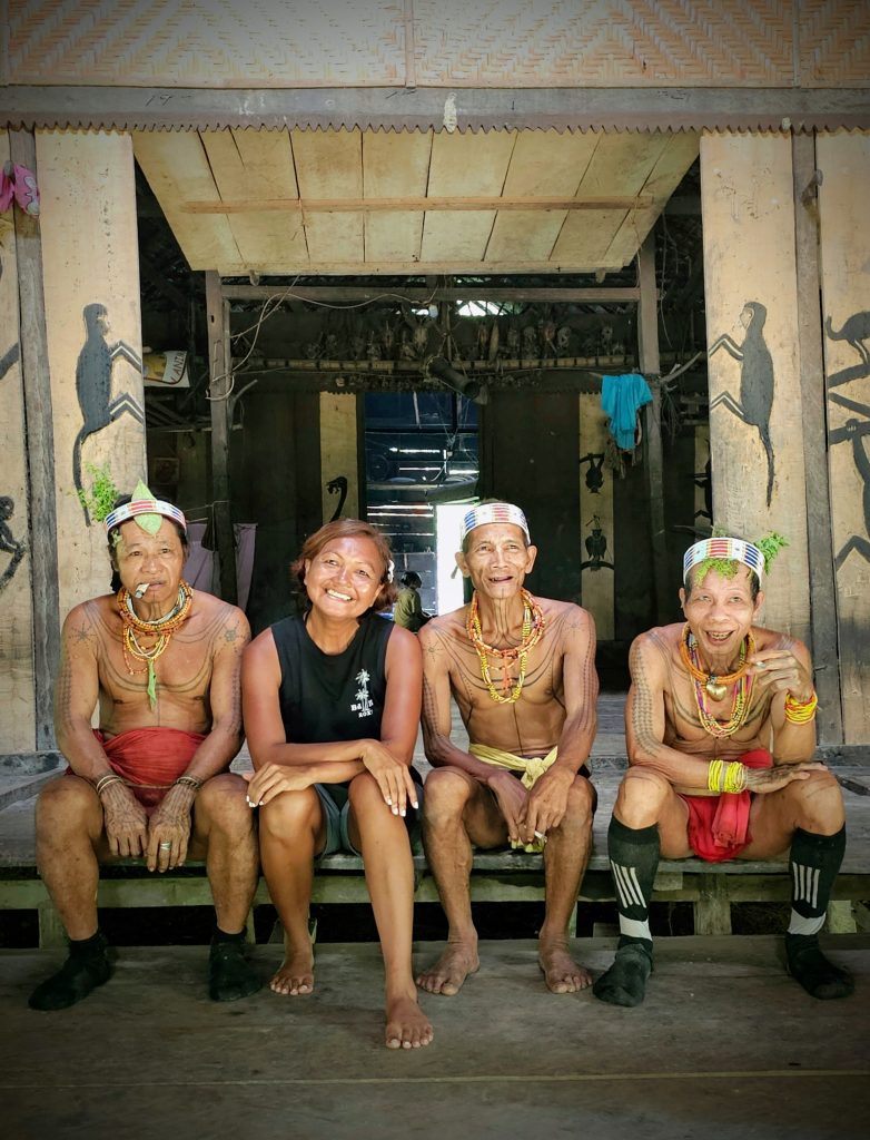 Shannim with several Mentawai shamans inside the uma community in Siberut, Indonesia.