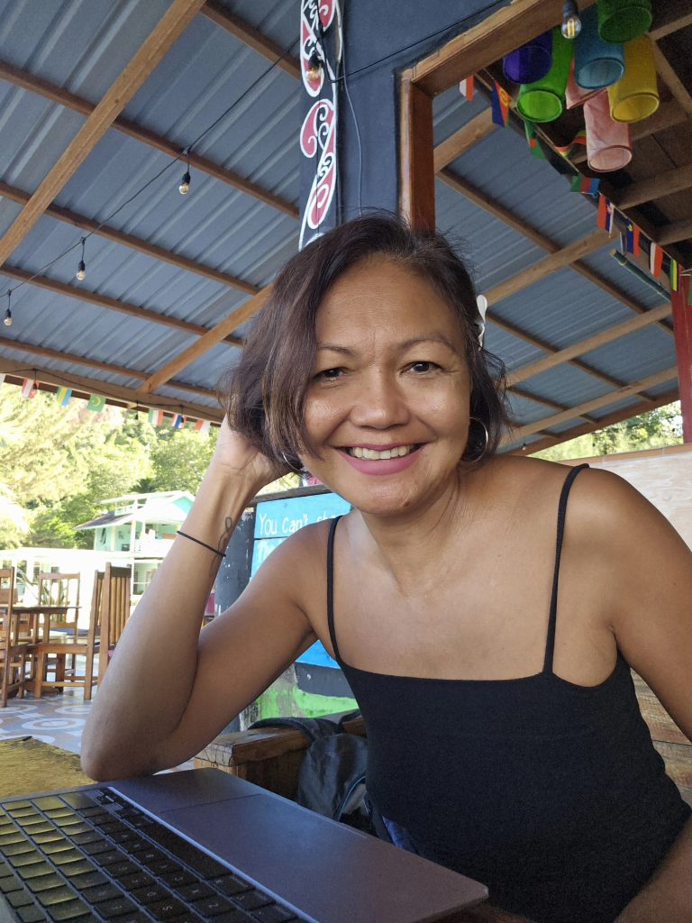 Shannim writing at Ricky's Beach House in Sungai Pinang, West Sumatra