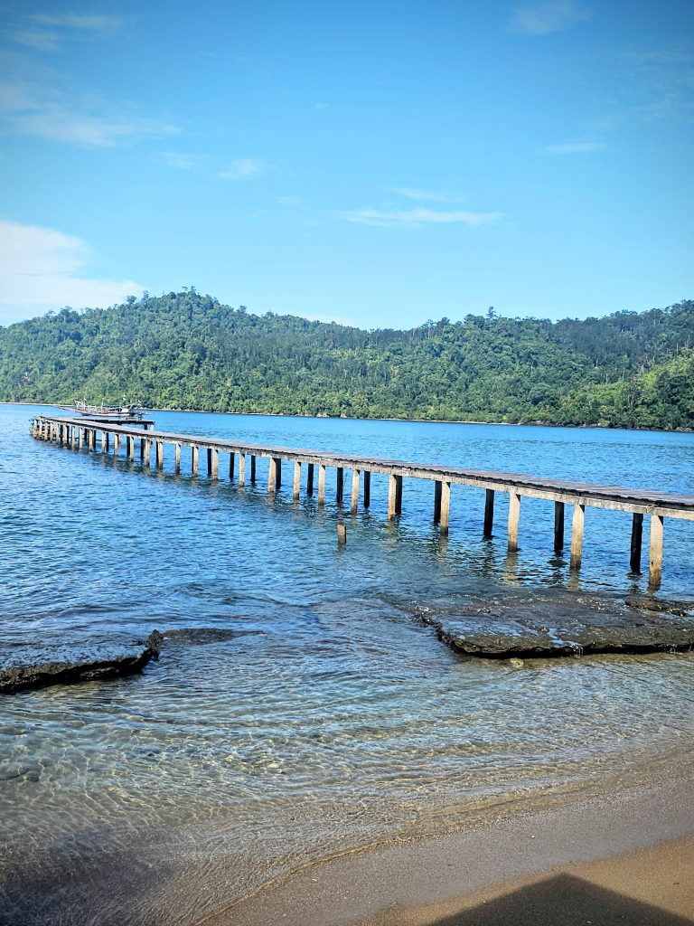 Wooden jetty at Ricky Beach House in Sungai Pinang, West Sumatra
