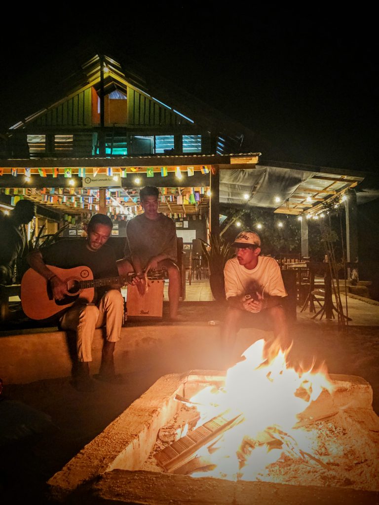 Staff playing live music at beach bonfire under the stars at Ricky's Beach House, Sungai Pinang, West Sumatra - authentic Indonesian travel experience