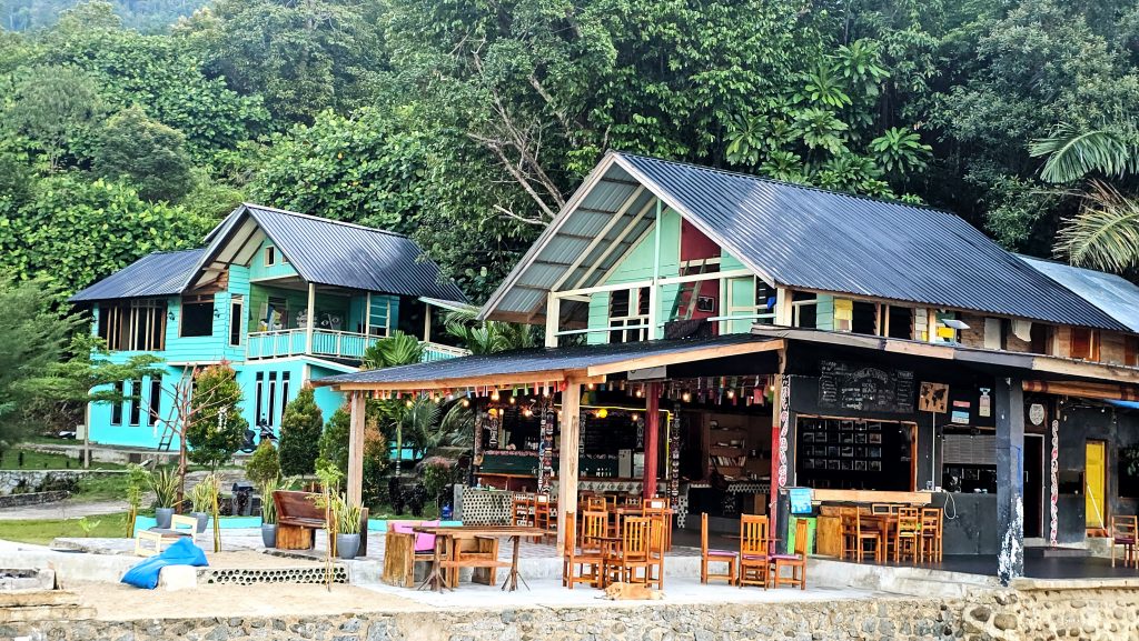 Beachfront restaurant dining area at Ricky's Beach House in West Sumatra, Indonesia