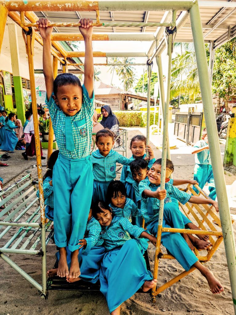 Kindergarten children playing freely at village school in Sungai Pinang, West Sumatra - authentic childhood joy beyond the travel algorithm
