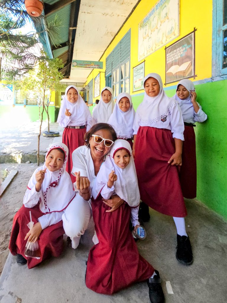 Shannim visiting local village school with enthusiastic children in Sungai Pinang near Ricky's Beach House, West Sumatra, Indonesia