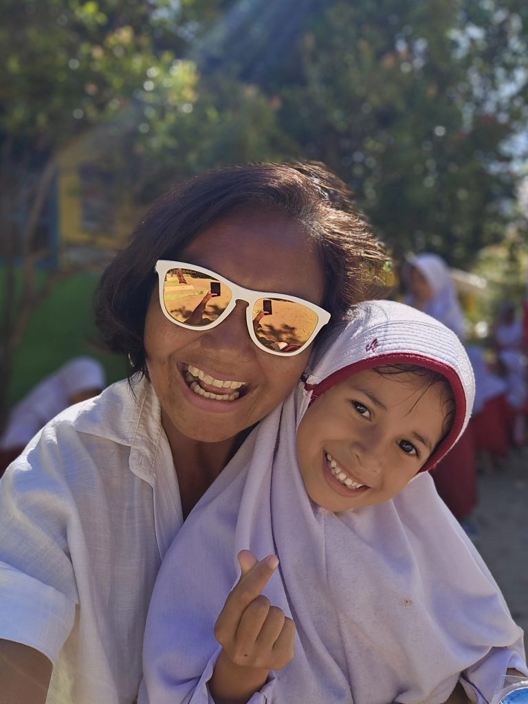 Travel writer Shannim with local school student in Sungai Pinang, West Sumatra