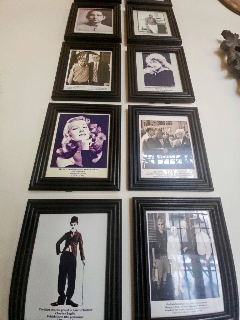 Wall display showing famous guests who stayed at E&O Hotel Penang over the years