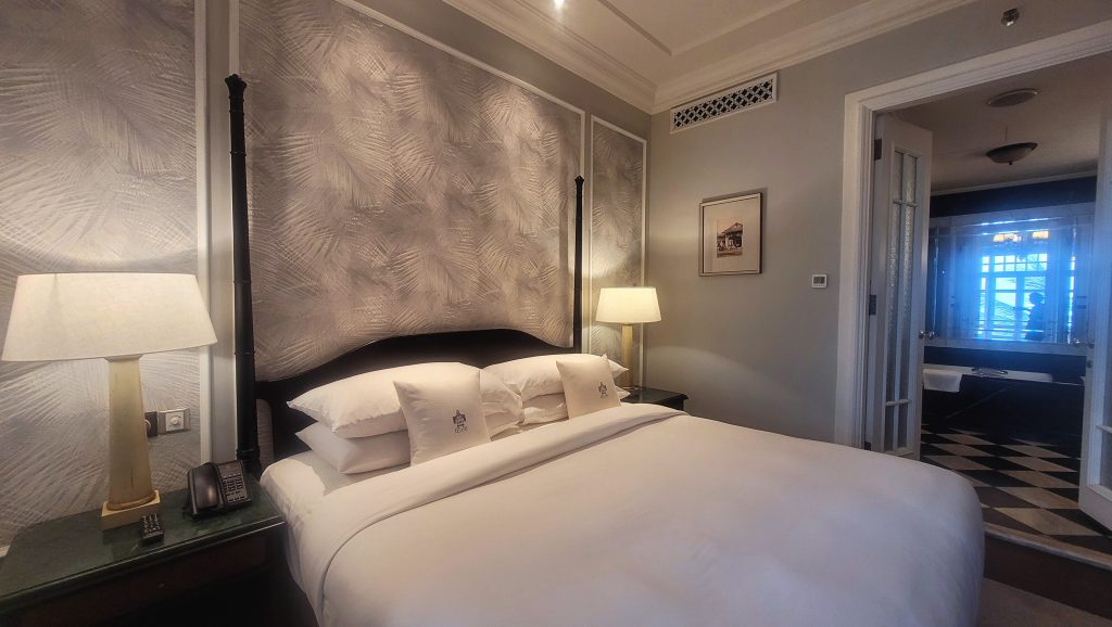 Bedroom in the Deluxe Suite at E&O Hotel Penang with a plush king size bed