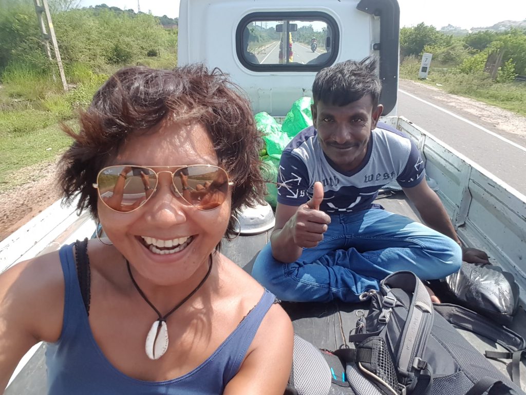 Shannim the writer Woman travelling in the back of a truck while hitchhiking in Sri Lanka