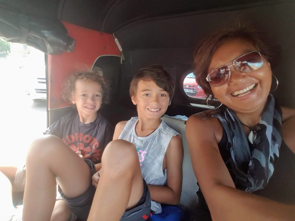 The writer and her two sons travelling light in a tuk tuk in Sri Lanka