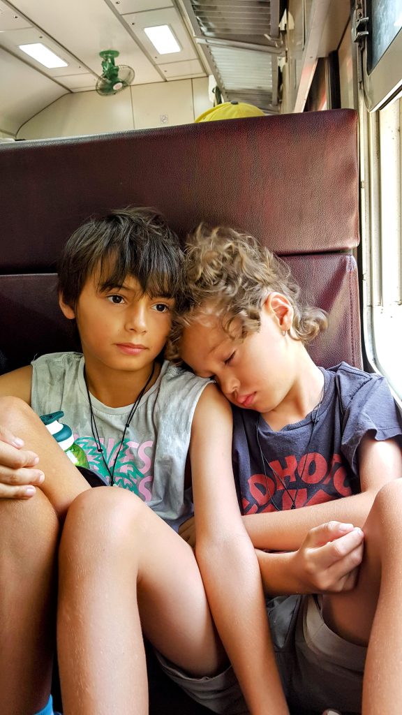 Brothers travelling light together on a local train in Sri Lanka