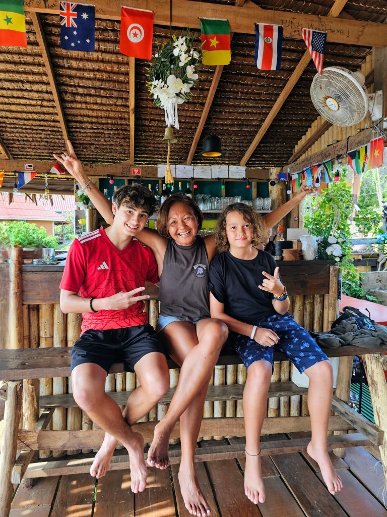 Mother and her children travelling light and smiling together in Thailand