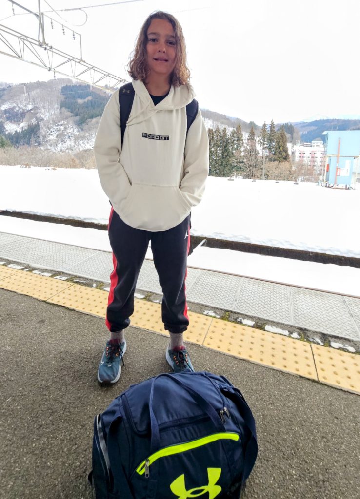 Young boy travelling light with a backpack in Japan