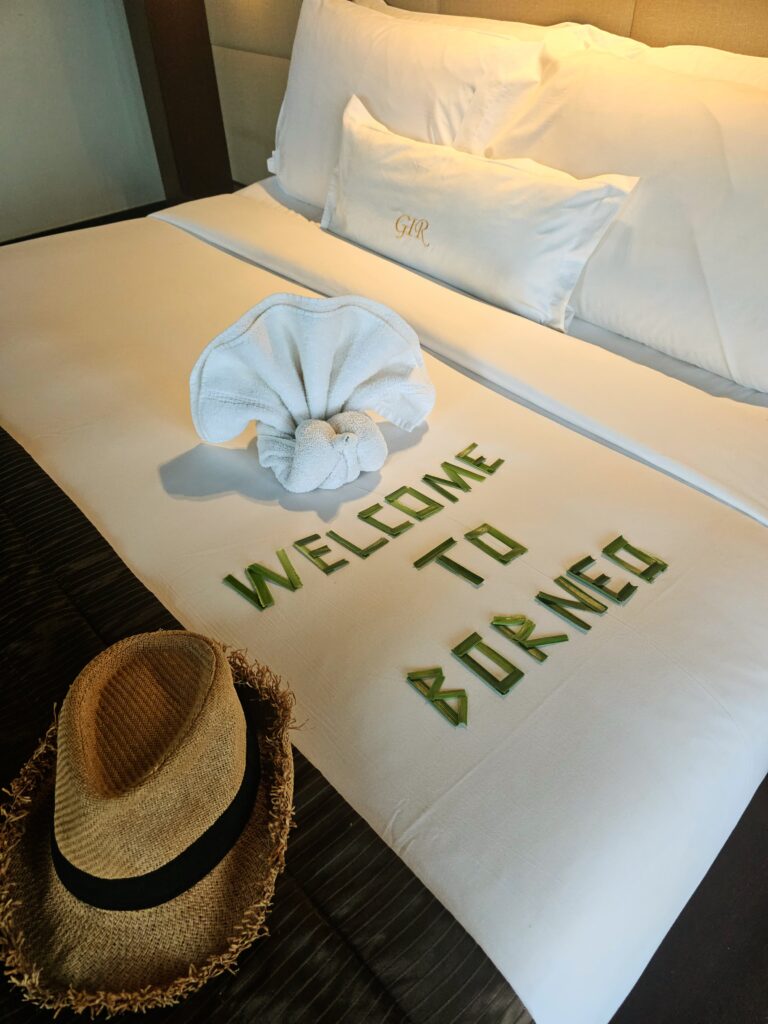 Welcome to Borneo message arranged with leaves on bed at Gaya Island Resort