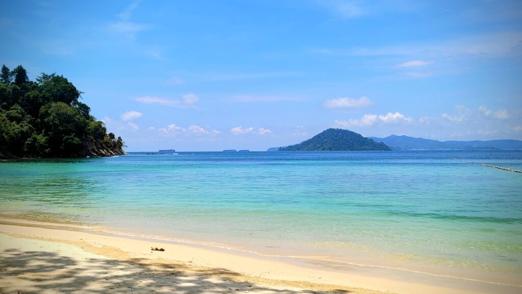 Tavajun Bay at Gaya Island Resort Sabah with turquoise sea and rainforest
