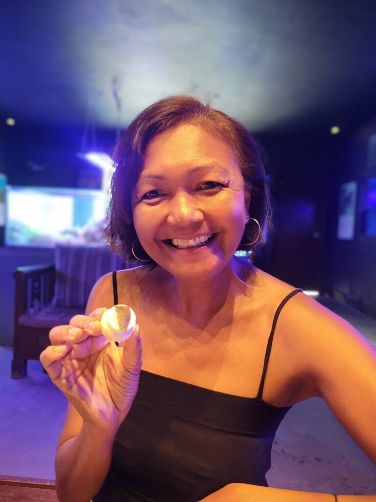 Travel writer Shannim holding coral for reef planting at Gaya Island Resort Sabah
