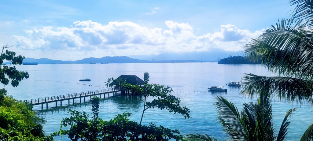 View from the jetty at Gaya Island Resort Sabah overlooking sea and rainforest
