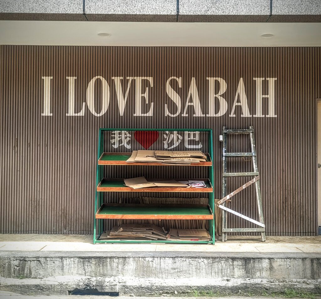 Street art mural on ageing shophouse wall Kota Kinabalu Sabah