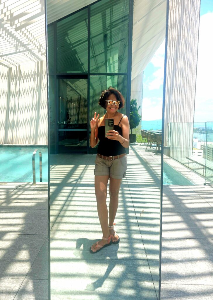 Writer Shannim at ON23 rooftop Hyatt Centric Kota Kinabalu overlooking the ocean