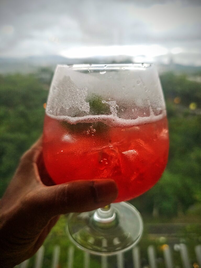 Handcrafted cocktail at ON23 rooftop bar with rainforest view Hyatt Centric Kota Kinabalu