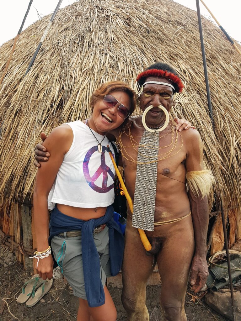 Writer Shannim with Dani warriors wearing traditional koteka at the Baliem Valley Festival.