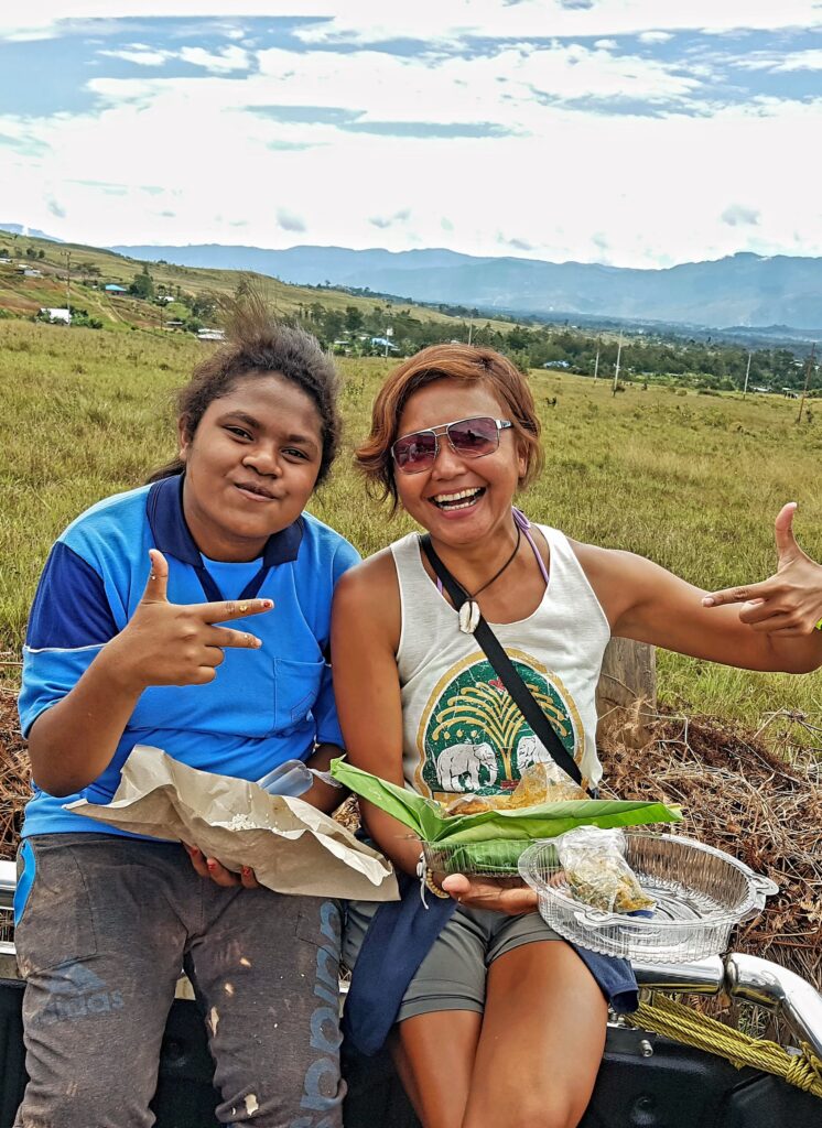 Alt text:
Travel writer Shannim with Dani people at the Baliem Valley Festival in Wamena.