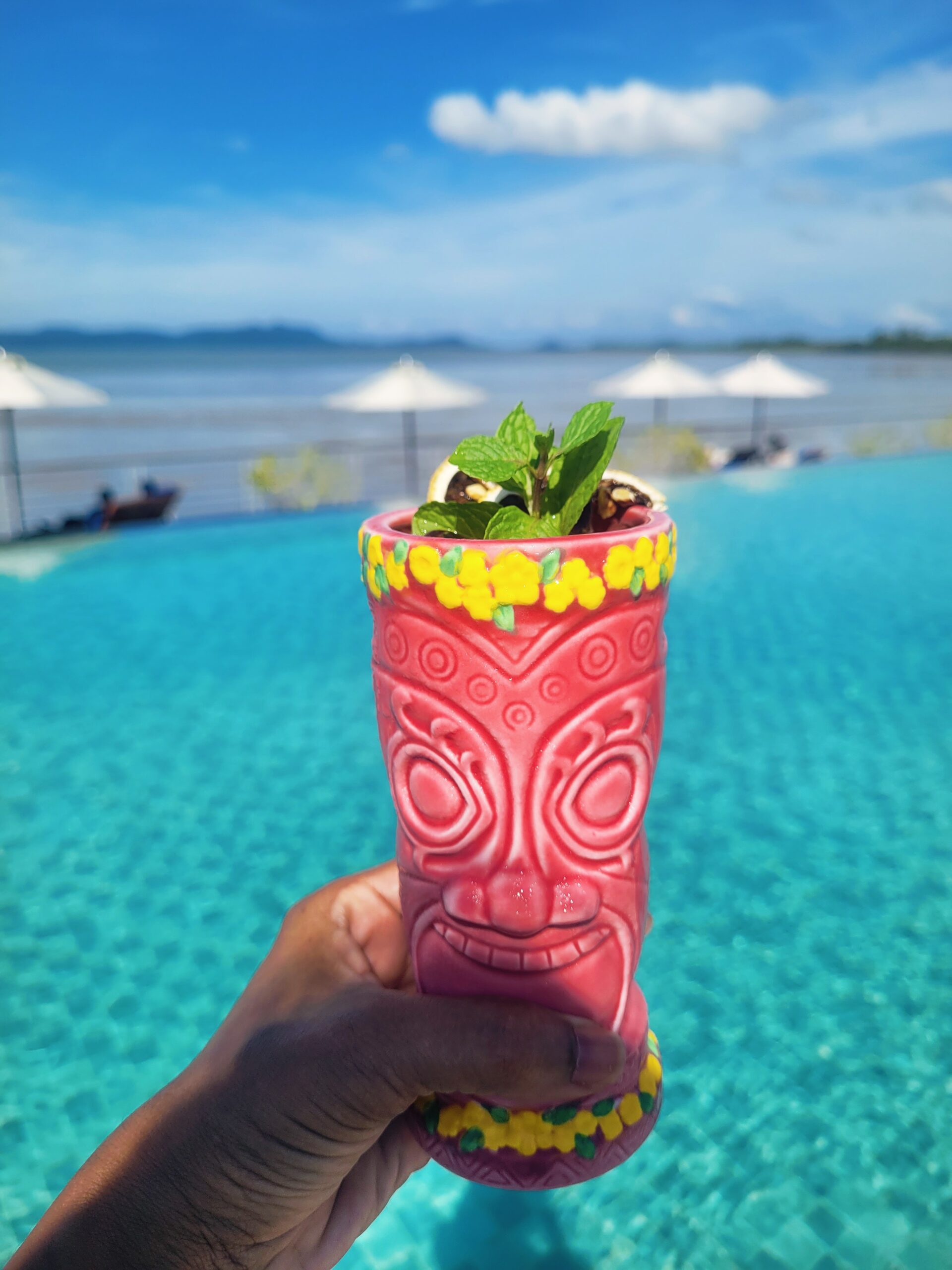 Poolside cocktail overlooking the South China Sea at Cove 55 boutique resort in Santubong, Sarawak