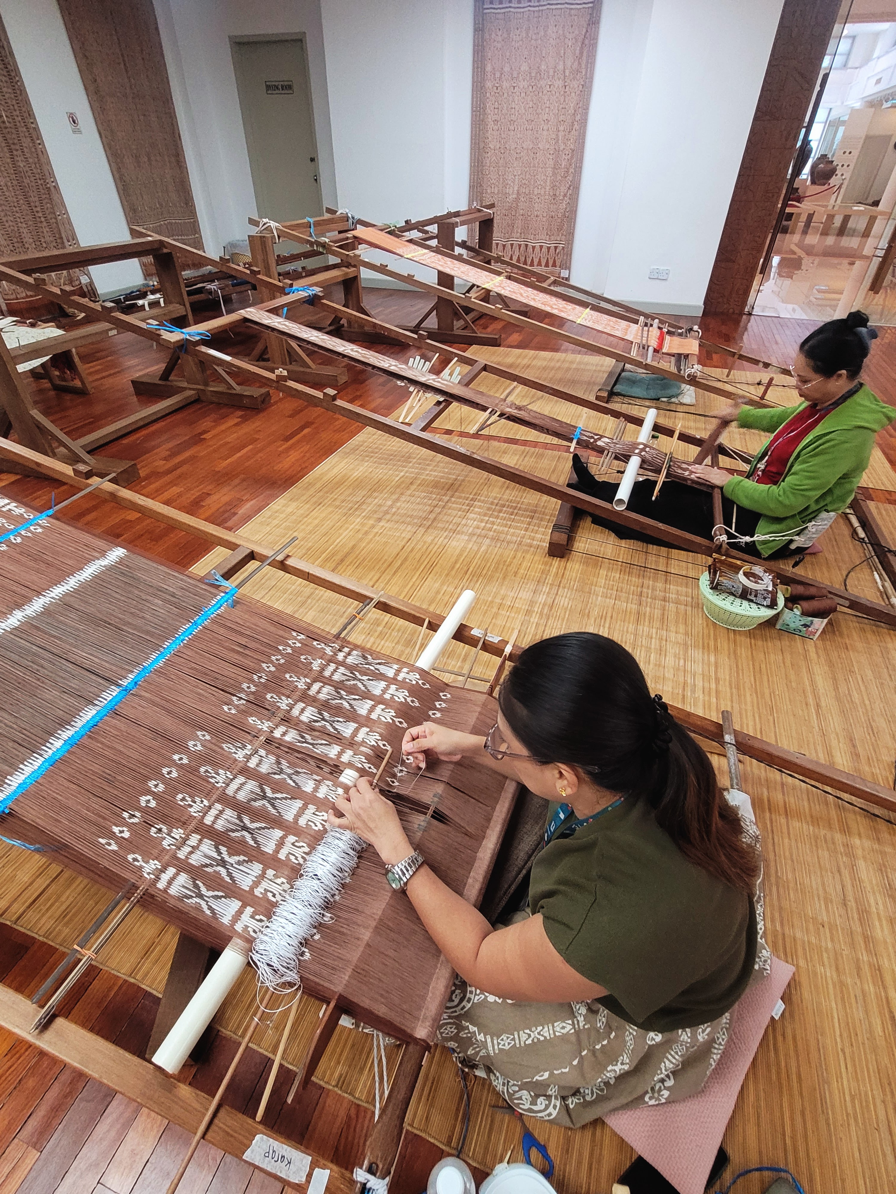 Iban women weaving traditional textiles at the Tun Jugah Foundation in Kuching, Sarawak