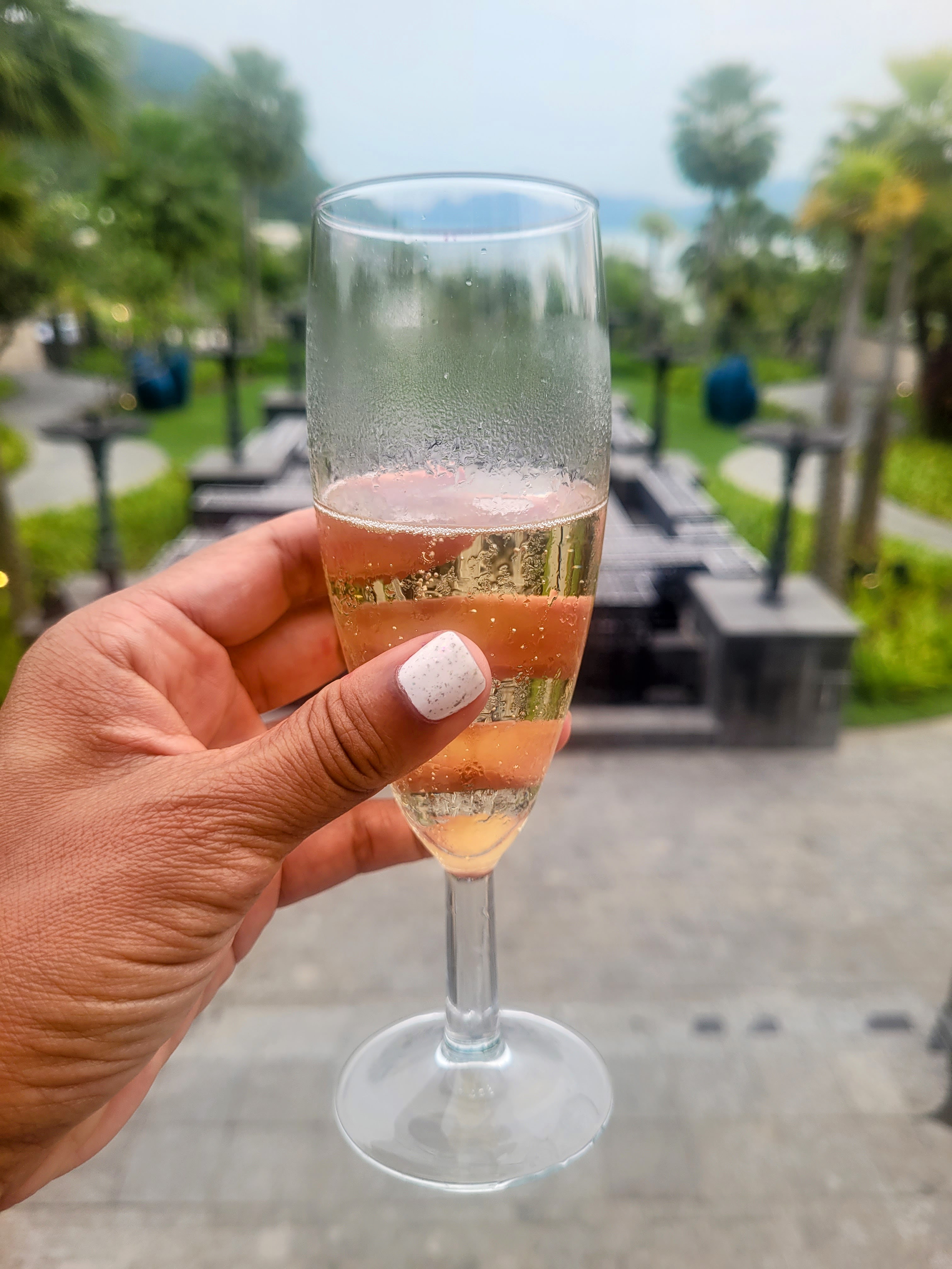 Glass of champagne in the courtyard at The St. Regis Langkawi
