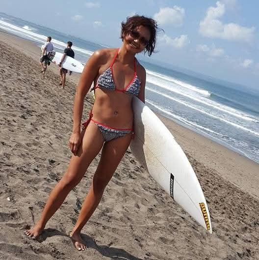 Travel writer Shannim surfing in Bali
